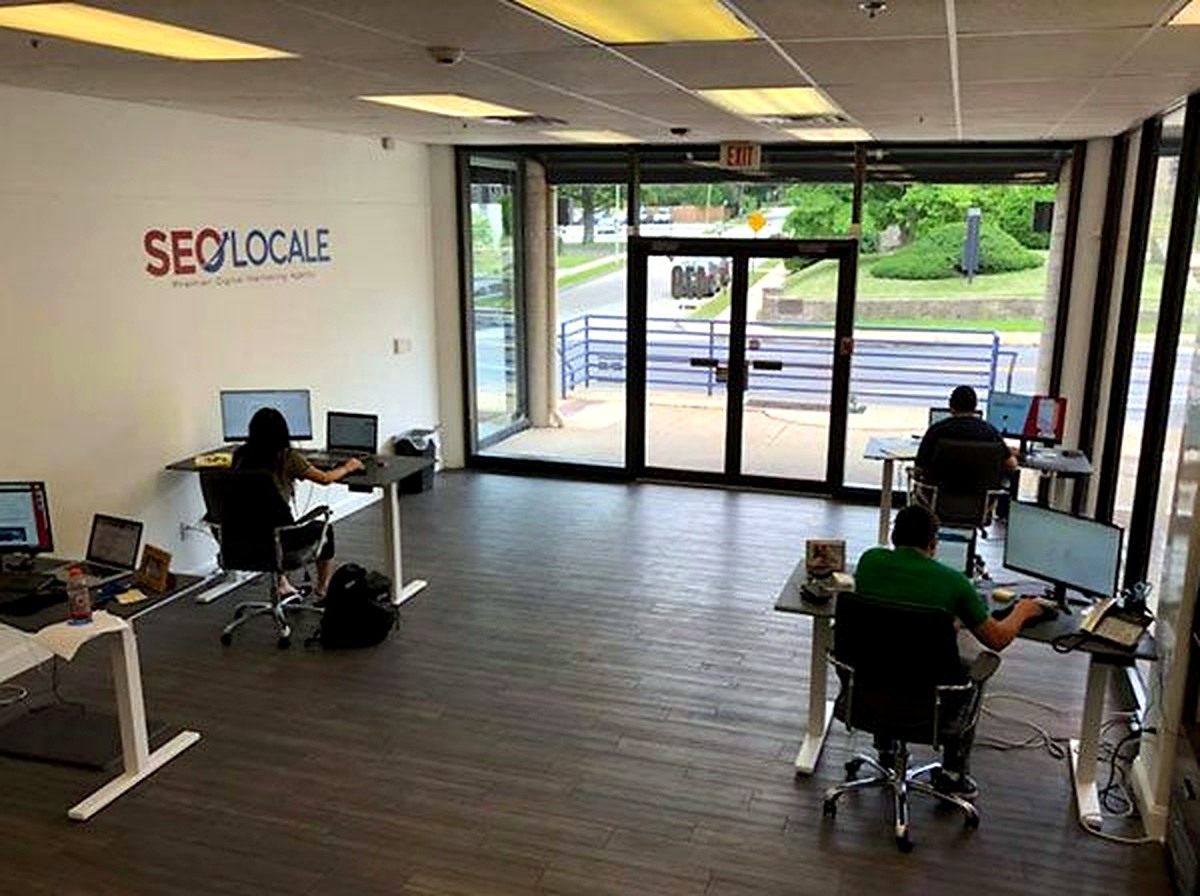 Kate and Paul working at desks during their summer 2018 web studio internship.